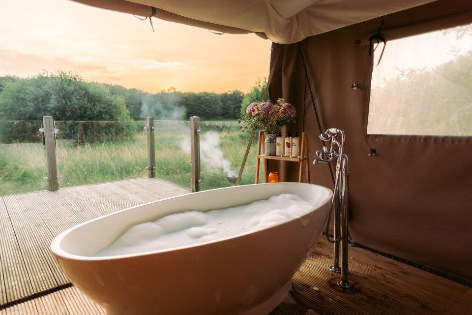 a bathtub filled with foam sits outside of a tent