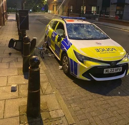 A police car was smashed up with an office chair