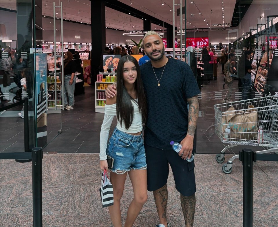 a man and a girl pose in front of a sephora store