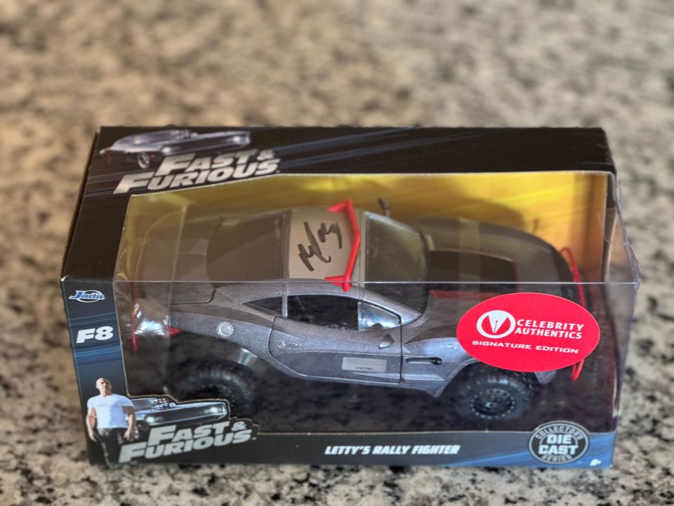 It comes with a die-cast model of itself signed by the actress who used it