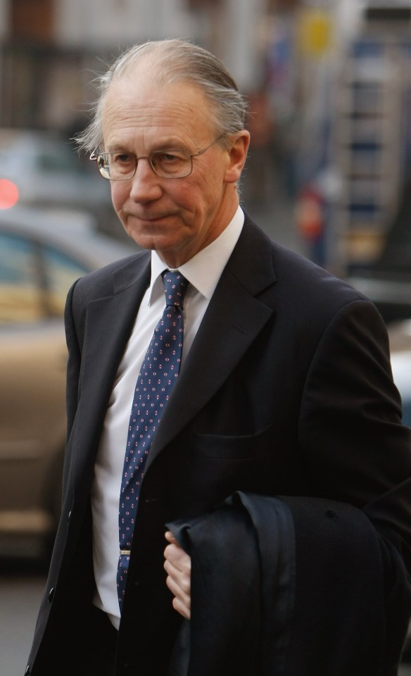 a man in a suit and tie is walking down the street