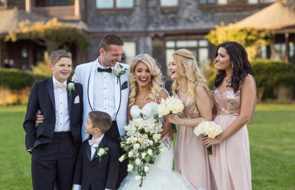 a bride and groom pose with their wedding party