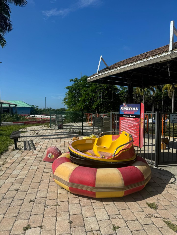 A rogue bumper car is left deserted on the pathway where thousands used to walk