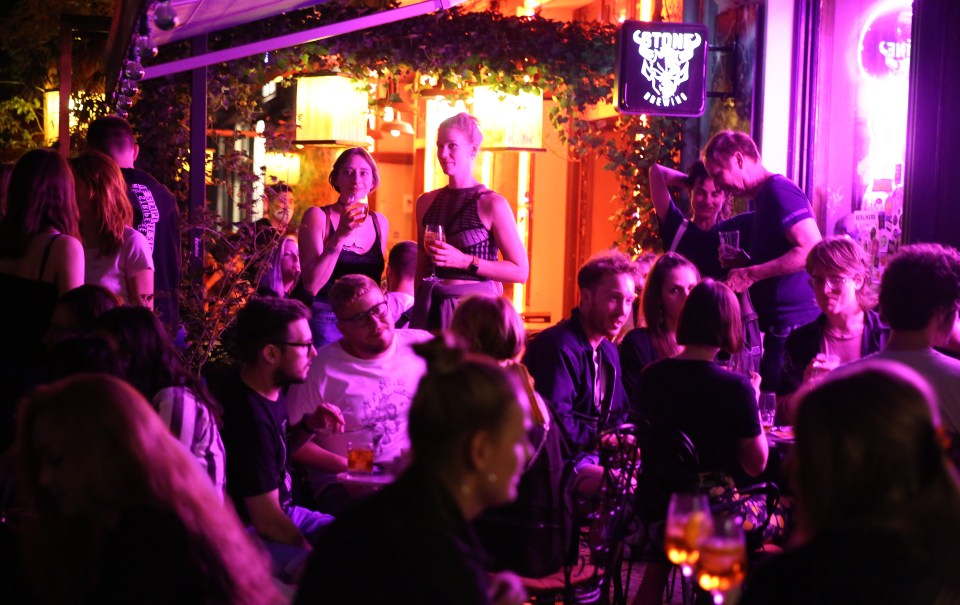 a group of people are gathered in front of a sign that says ' skull festival '