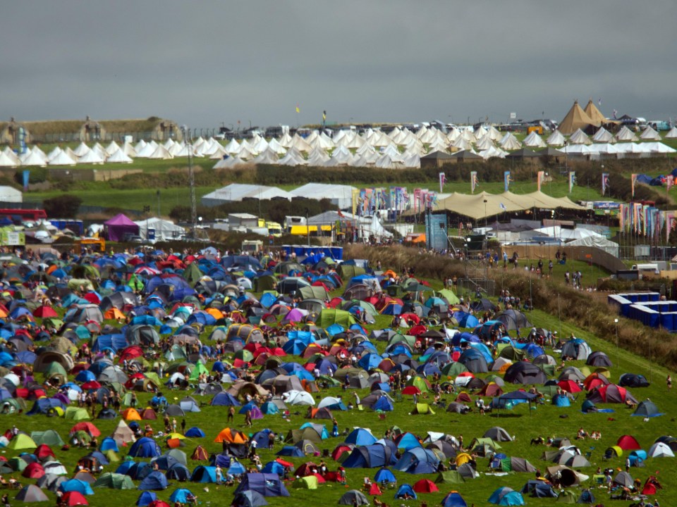 a field filled with lots of tents and people