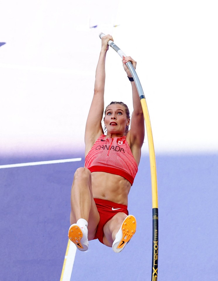 a woman in a red top that says canada is jumping over a pole