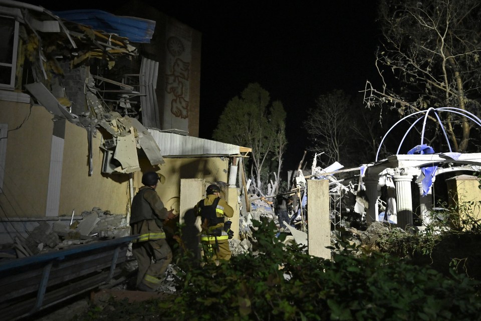 Ukrainian emergency services conducting a search and rescue operation in the rubble of the destroyed hotel