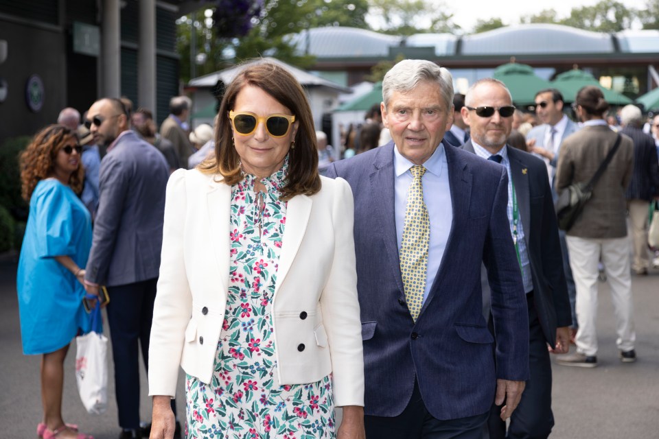 a man and a woman wearing sunglasses are walking in a crowd