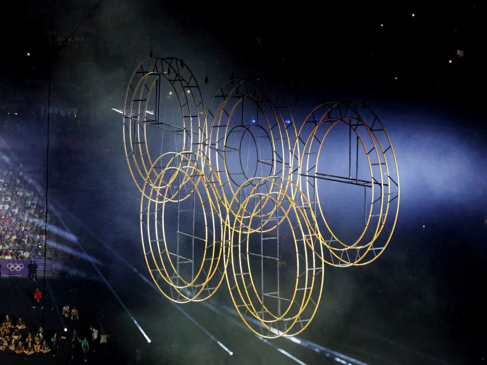 a large sculpture of the olympic rings floating in the air