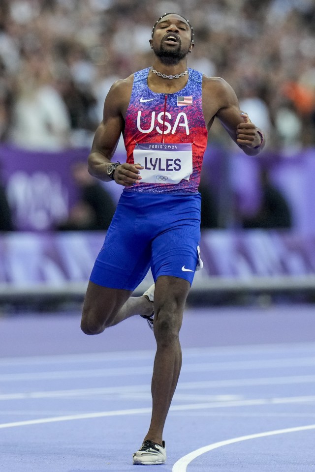 a man wearing a usa jersey is running on a track