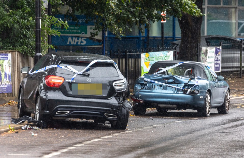 Damaged cars in Wandsworth, London, this morning as bad weather causes dangerous driving conditions for the Bank Holiday getaway