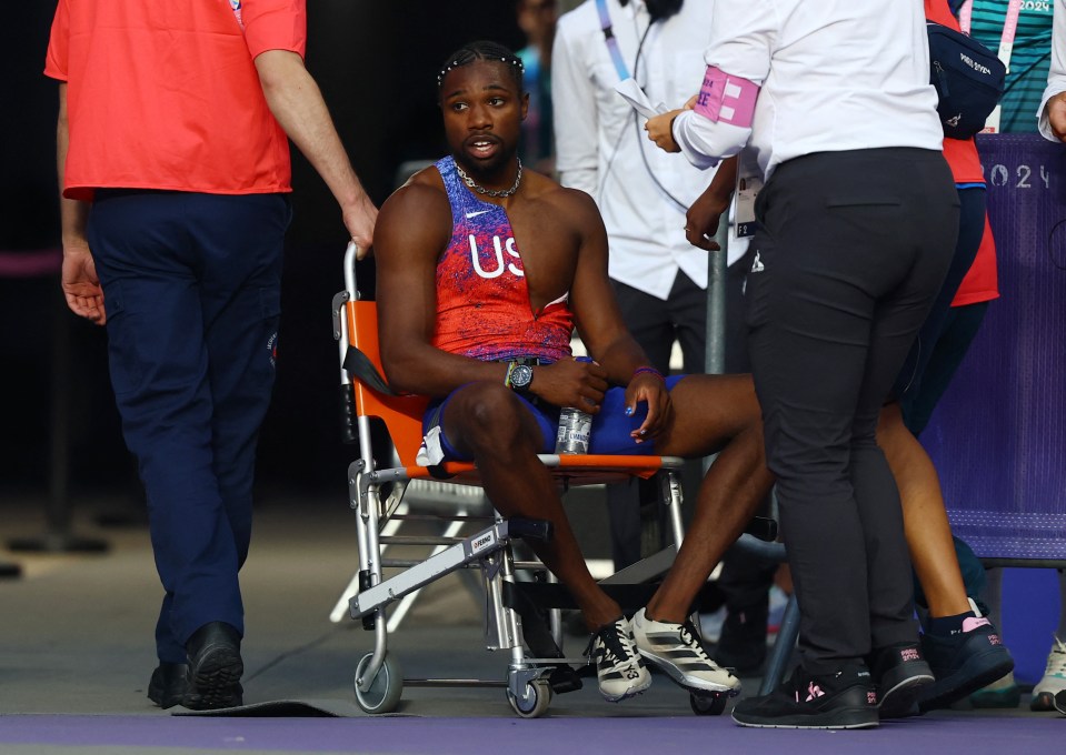 a man in a us shirt sits in a wheelchair