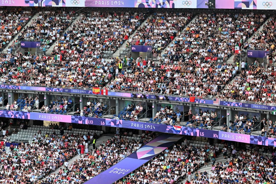 a crowded stadium with a banner that says paris 2024