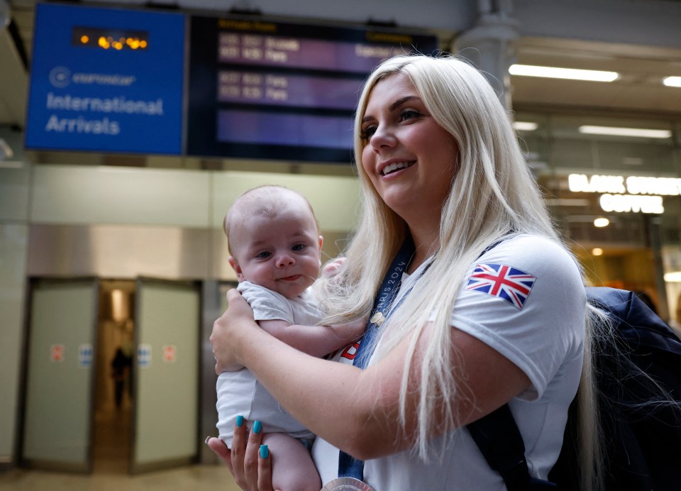 Shooting skeet women's silver medallist Britain's Amber Rutter was joined by her baby