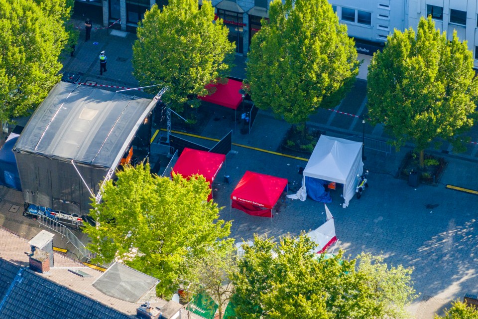 an aerial view of a street with red and white tents and a sign that says ' sparkasse ' on it