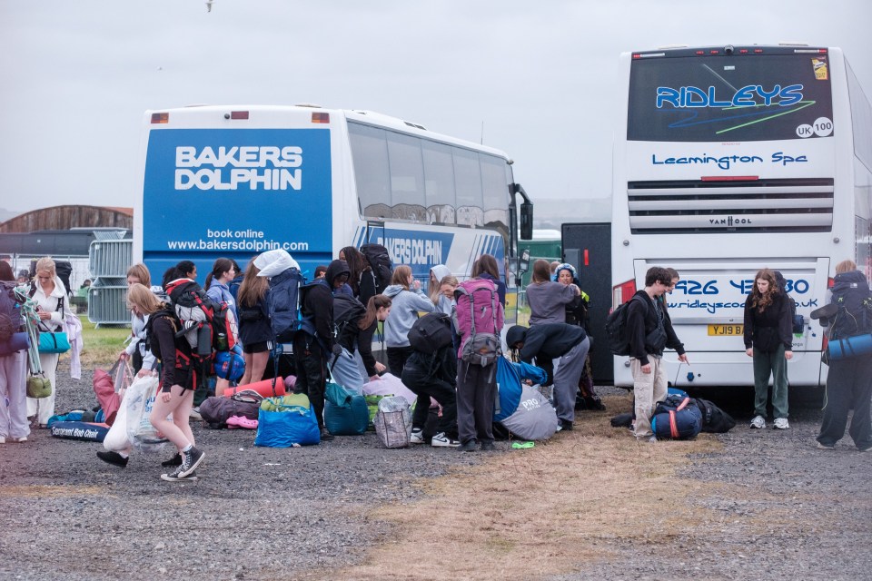 a group of people are boarding a bakers dolphin bus