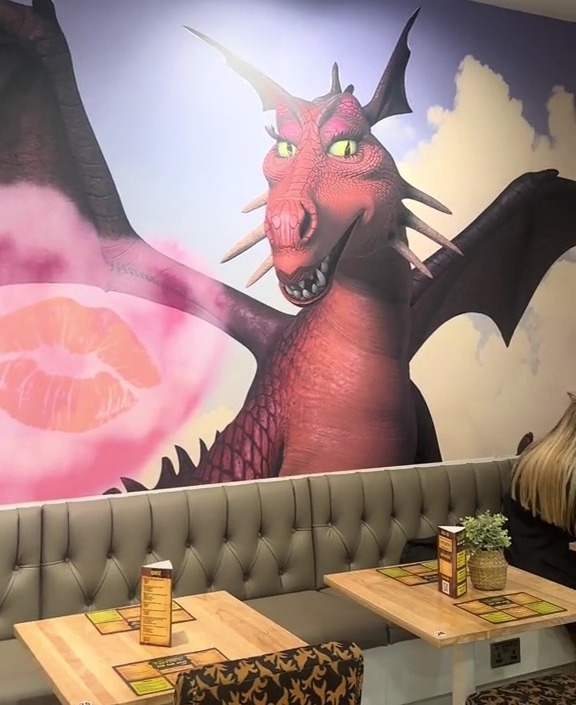 a restaurant with a mural of shrek on the wall