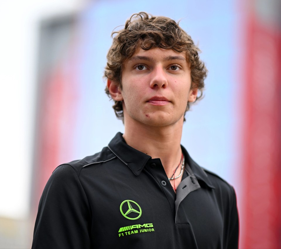 a young man wearing a shirt that says amg f1 team junior