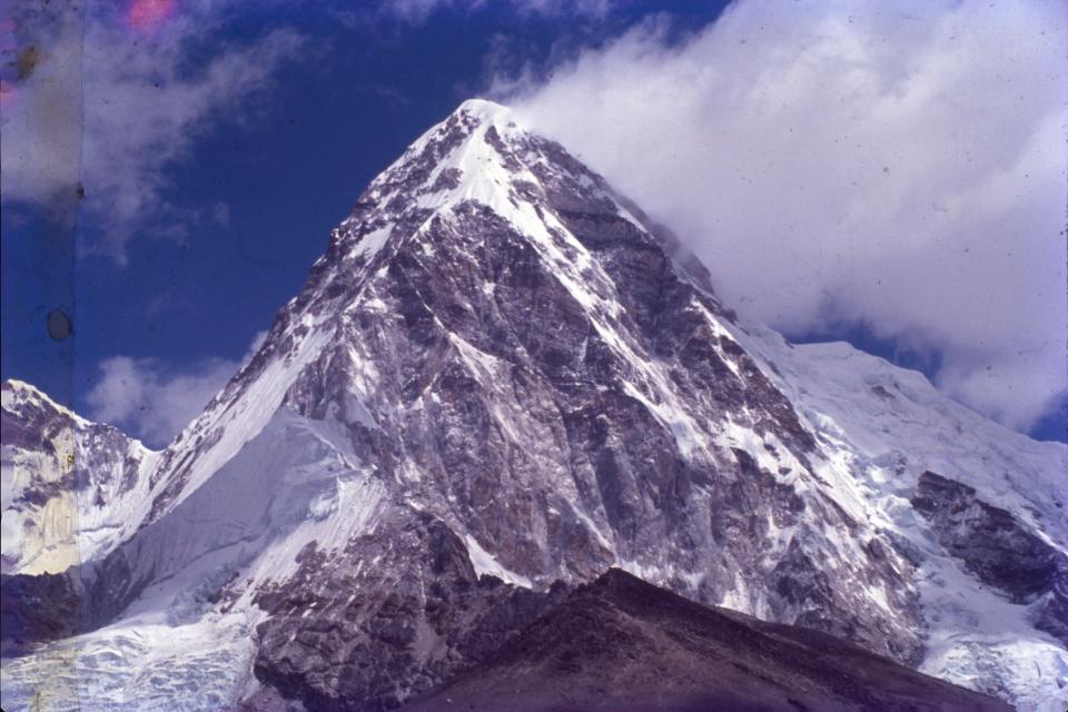 a snowy mountain with a blue sky in the background