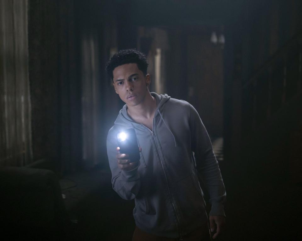 a man holding a flashlight in a dark room