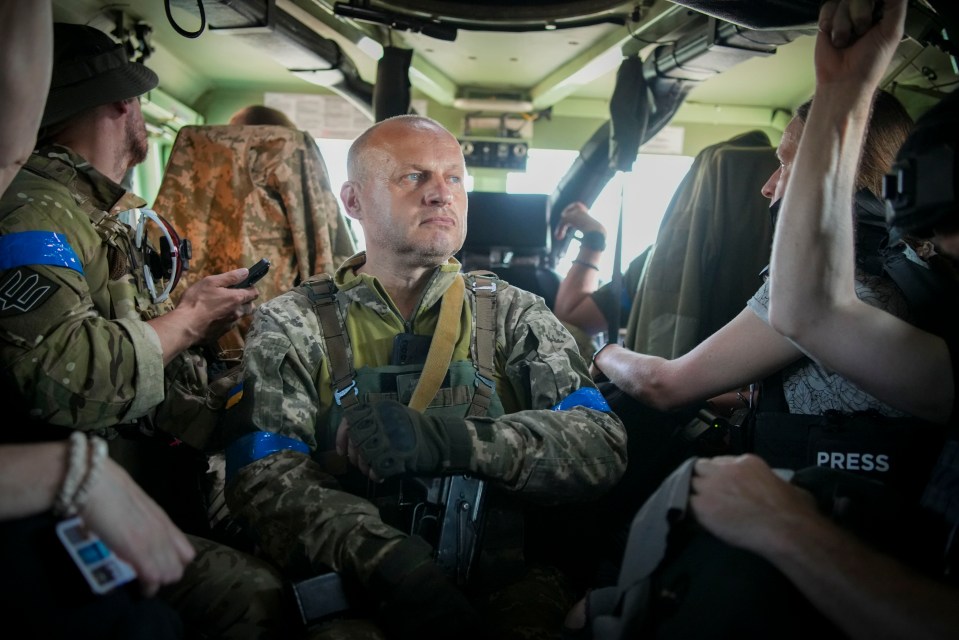 Ukrainian press officer Vadym inside an armoured vehicle with The Sun's team