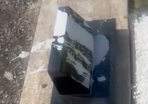 a black box is sitting on top of a concrete surface .