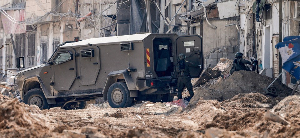 Israeli soldiers disembark off an armoured vehicle as they take position during an army operation in Tulkarm in the north of the occupied West Bank on August 29, 2024. Israel on August 28 launched a large-scale operation in the occupied West Bank where the military said it killed Palestinian fighters, as the nearly 11-month-old Gaza war showed no signs of abating. (Photo by Jaafar ASHTIYEH / AFP) (Photo by JAAFAR ASHTIYEH/AFP via Getty Images)