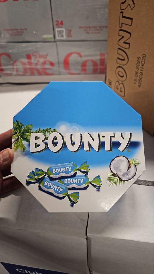 a person is holding a box of bounty candy