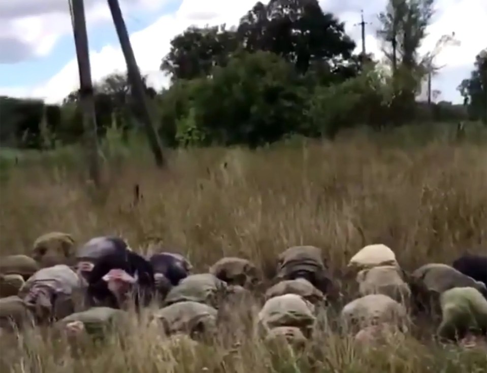 Three rows of Russian soldiers can be seen saying 'Glory to Ukraine' in the footage