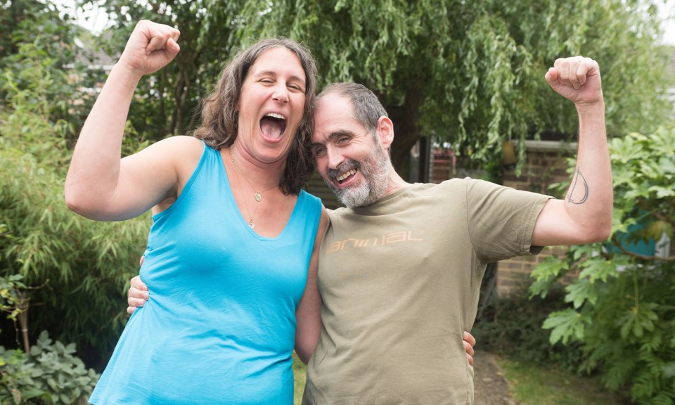 a man and a woman are posing for a picture and the man is wearing a shirt that says animal