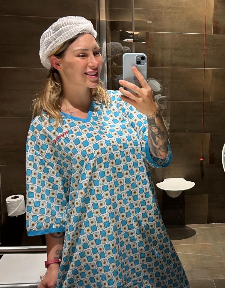 a woman taking a picture of herself in a bathroom