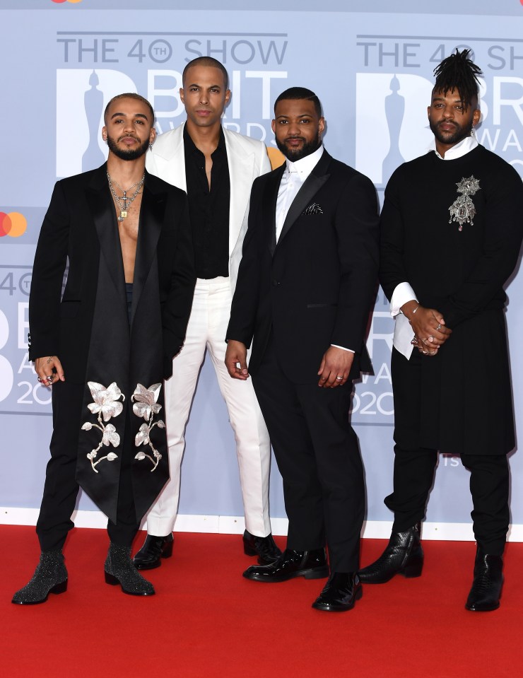 a group of men standing on a red carpet that says the 40 show