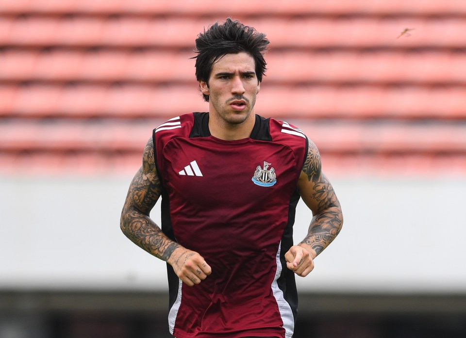 a man running on a field wearing an adidas shirt