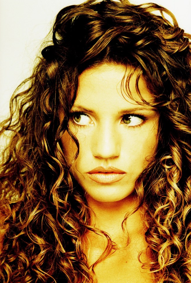 a woman with curly hair has a serious look on her face