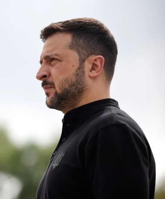 a man with a beard is wearing a black shirt with a green eagle on it