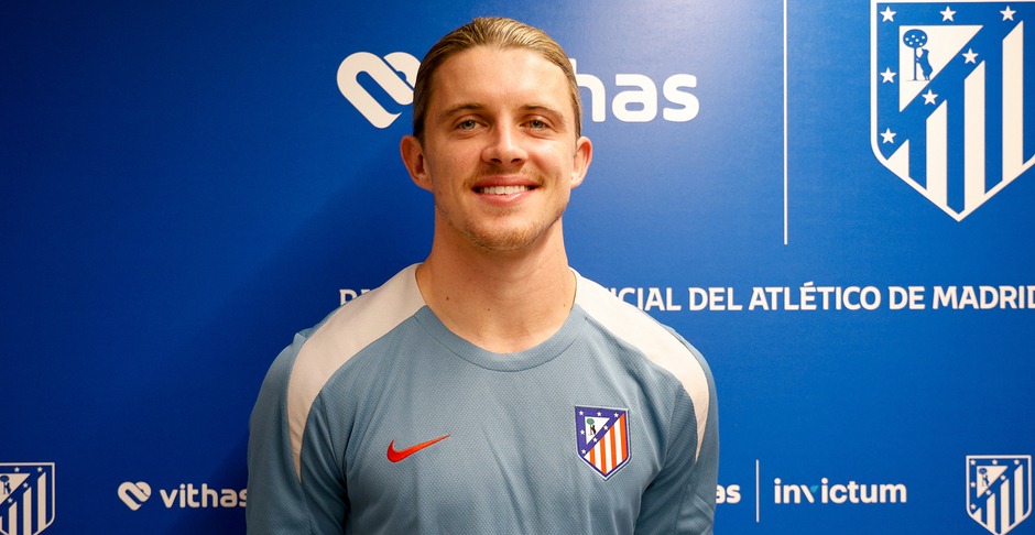 a man stands in front of a blue wall that says invictum