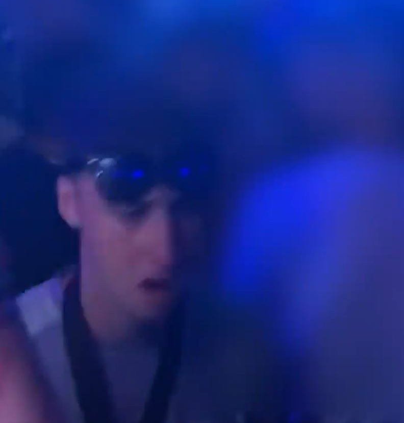 a blurry picture of a man wearing sunglasses in a dark room .