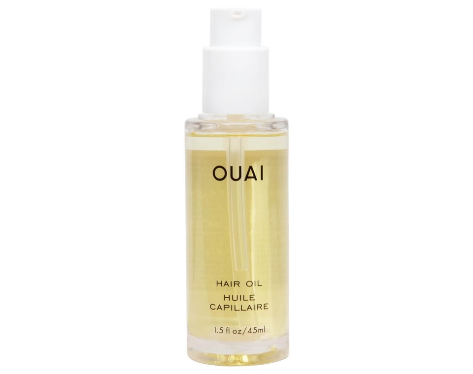 a bottle of ouai hair oil on a white background