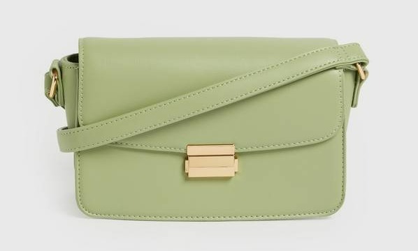 a green leather purse with a gold buckle and strap