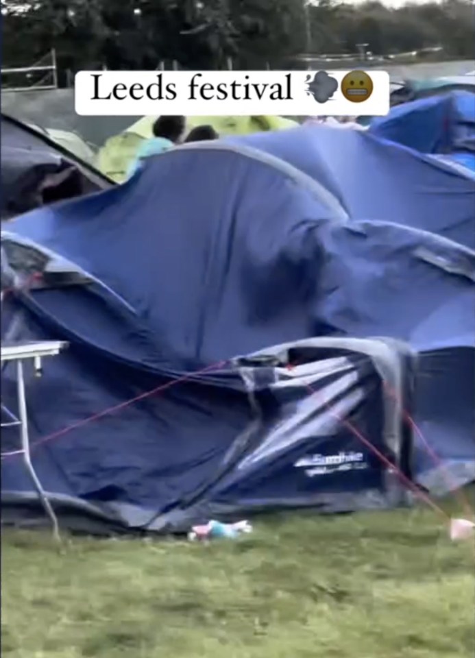 a bunch of tents are stacked on top of each other in a field .