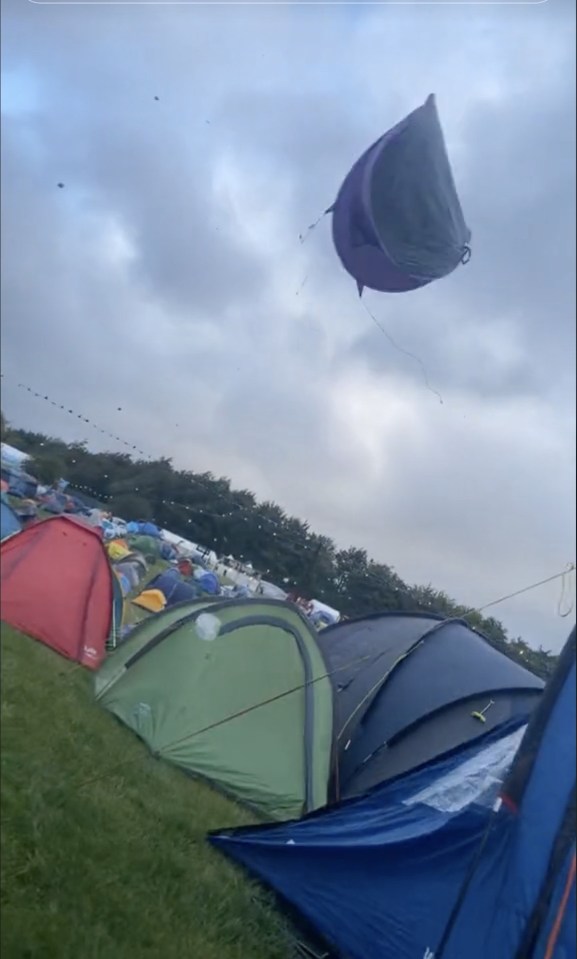 A tent goes flying through the air during strong winds as Storm Lilian hit Leeds Festival