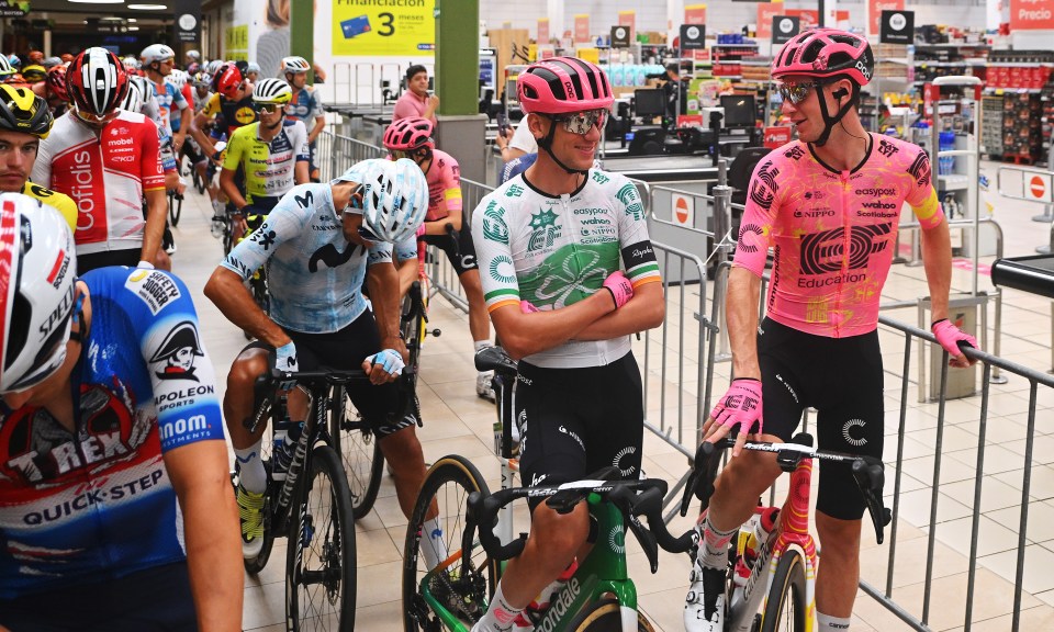 a cyclist wearing a pink jersey with the word education on it