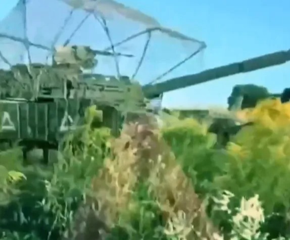 a painting of a military vehicle driving through a field of tall grass .