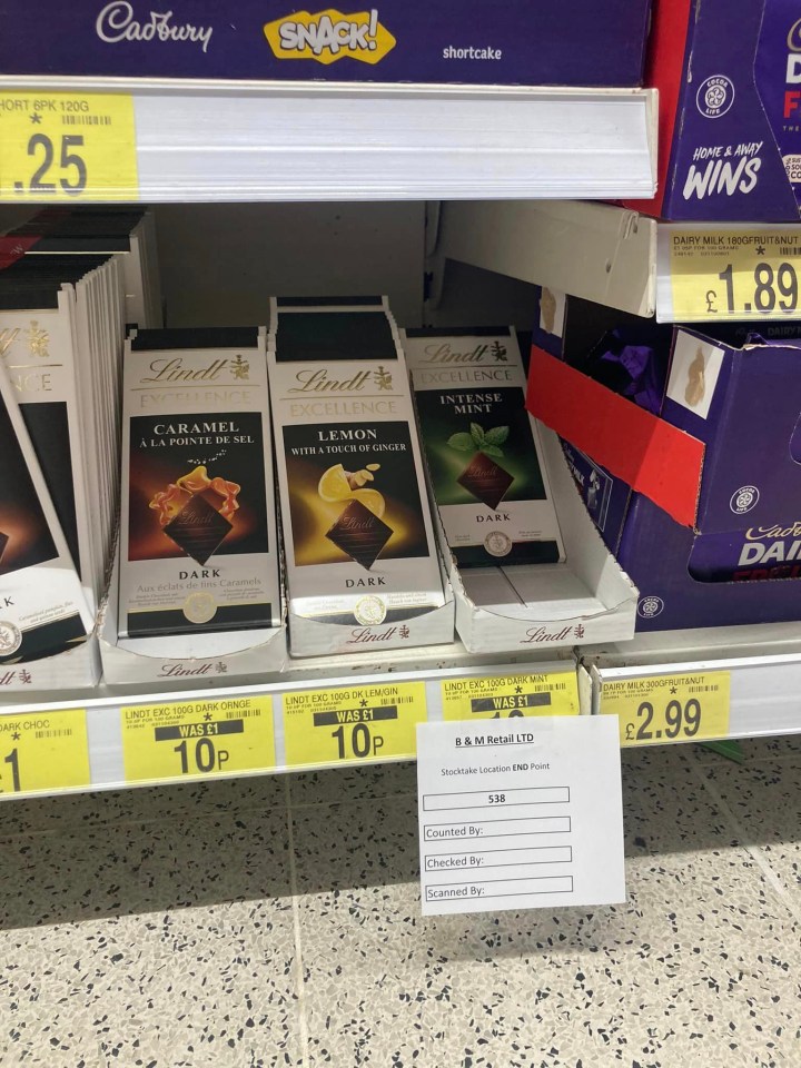 a store shelf with lindt chocolate bars on it