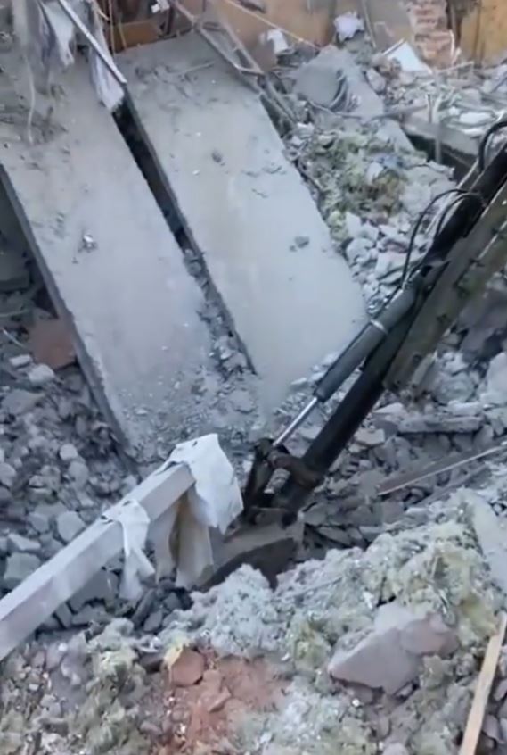 Rescue workers dig through rubble