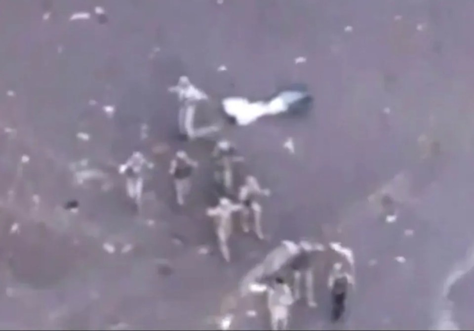 an aerial view of a group of people standing on a concrete surface .