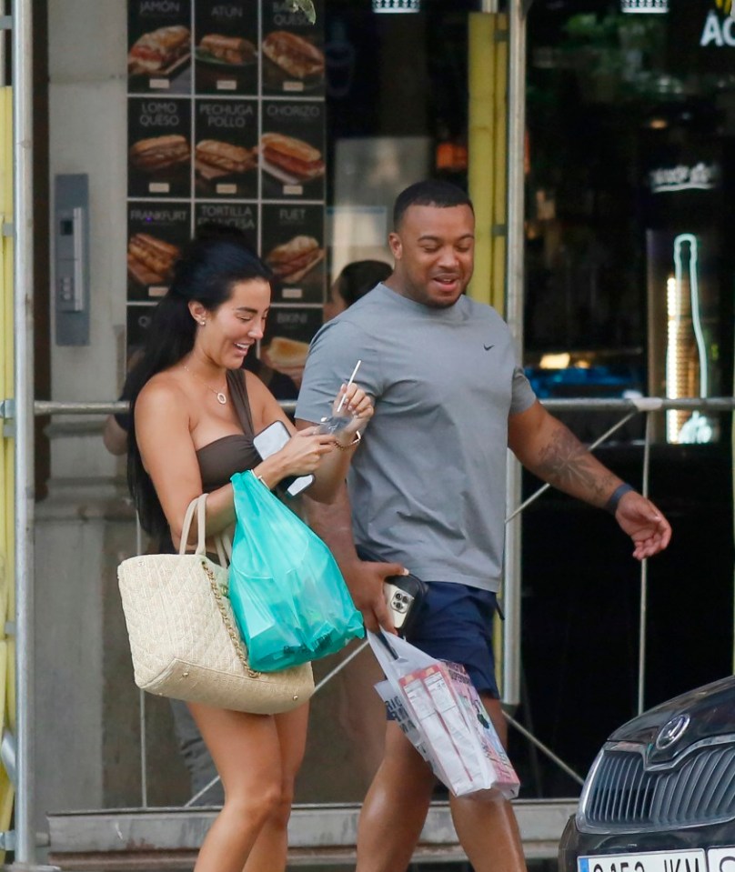 The couple were seen laughing as they hit the shops in Barcelona