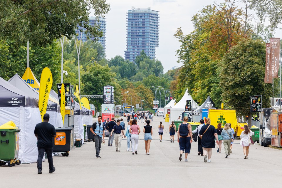 People walk past closed merchandising booths for fan items of US mega-star Taylor Swift on August 8, 2024 near the Ernst Happel Stadium in Vienna, Austria, after her three scheduled concerts were cancelled following the arrest of an Islamic State sympathiser in connection with an attack plot. The Vienna leg of a tour by American mega-star Taylor Swift has been cancelled after Austria arrested an Islamic State sympathiser in connection with an attack plot, the organisers said on August 7, 2024. Authorities had earlier confirmed the arrest of a 19-year-old sympathiser of the armed group for allegedly planning an attack in the Vienna region, warning he had a "focus" on Swift's three upcoming shows. About 65,000 spectators were expected at each show scheduled for August 8, 9 and 10. (Photo by FLORIAN WIESER / APA / AFP) / Austria OUT (Photo by FLORIAN WIESER/APA/AFP via Getty Images)