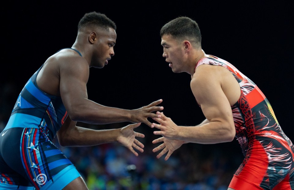 PARIS, FRANCE - AUGUST 06: Akzhol Makhmudov (red) of Kyrgyzstan and Kamal Ameer Bey (blue) of United States in their men's greco-roman 77kg wrestling early rounds match at the Champ-de-Mars Arena during the Paris 2024 Olympic Games, in Paris, France on August 6, 2024. (Photo by Aytac Unal/Anadolu via Getty Images)