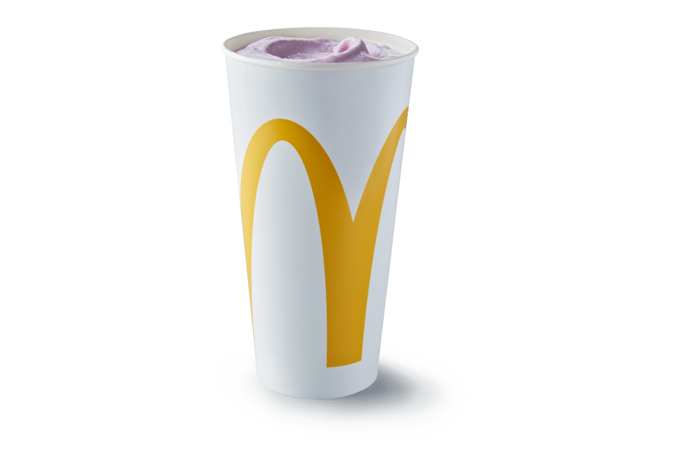 a tall white cup with a yellow m on it